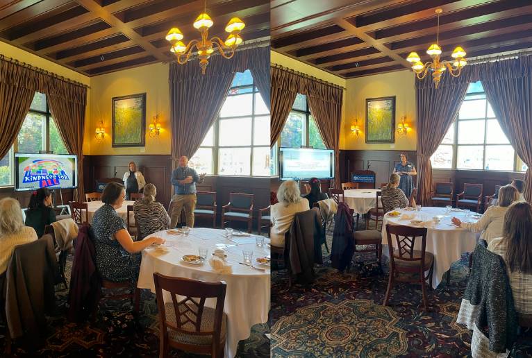 photo of a small banquet room with a presenter in front of space